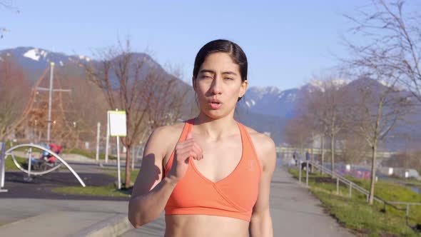 Sporty Hispanic woman doing high kick toward camera, Closeup