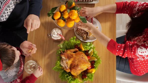 Family Eat Chicken Sitting at Celebration Dinner on Christmas Eve