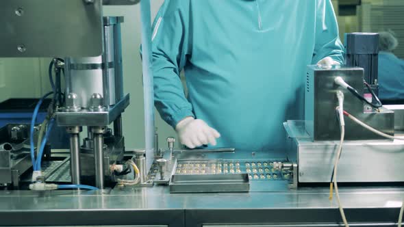 Man Works at Medical Laboratory Checking Capsules