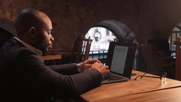 Black Businessman Using Laptop for Analyzing Data Stock Market Stock Exchange Trading Online