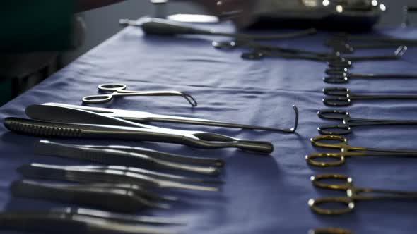 Close-up of surgeon arranging surgical tools on tray