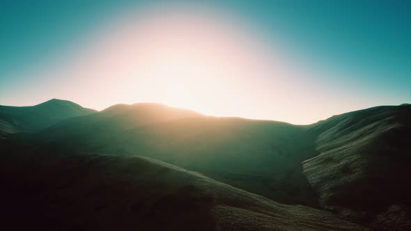 Hills with Rocks at Sunset