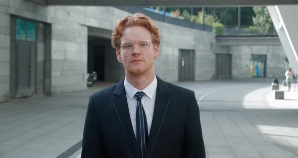 Portrait Handsome Businessman in Glasses Walking Outside Near Office Building