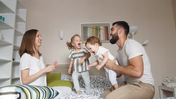 Mother, Father and Their Adorable Kids Playing Together.