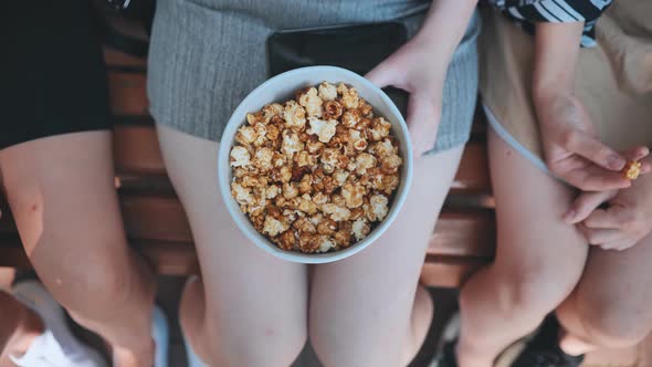 Friends Eating Popcorn on the Street