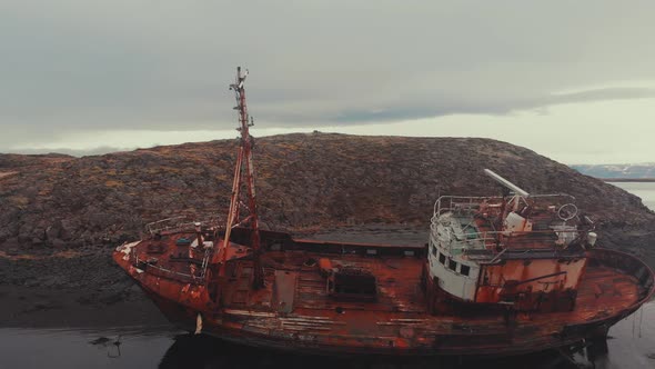 Rusty ship near river coast