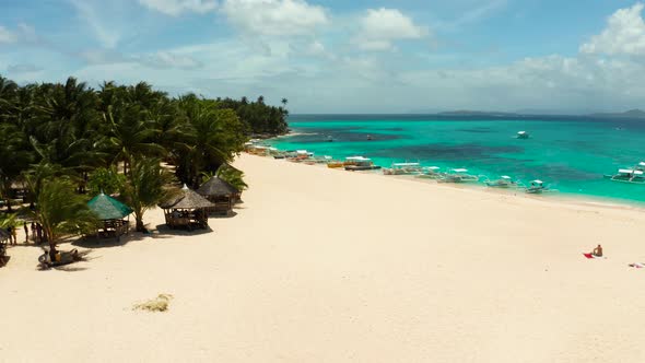 Tropical Daco Island with a Sandy Beach and Tourists