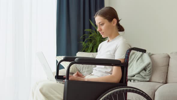 Motivated Freelancer is Working Typing in Laptop Sitting in Wheelchair at Home