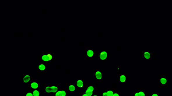 Bright Green Water Gel Balls Bouncing Against a Black Background