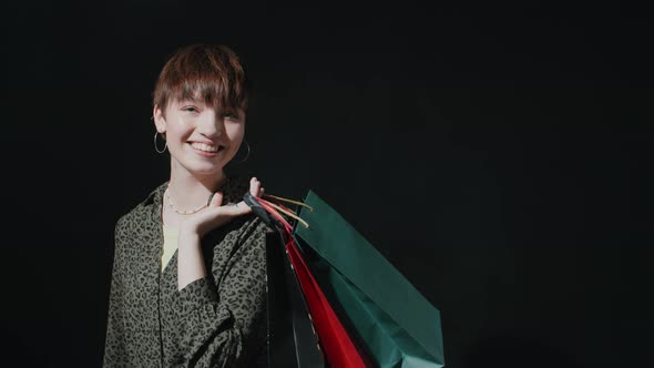 Portrait of Cheerful Girl with Shopping Bags