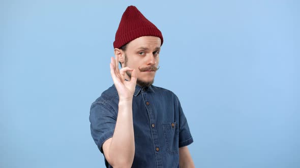 Portrait of Attractive Man 20s in Casual Jean Shirt Gesturing Ok Sign Meaning Good Choice Isolated