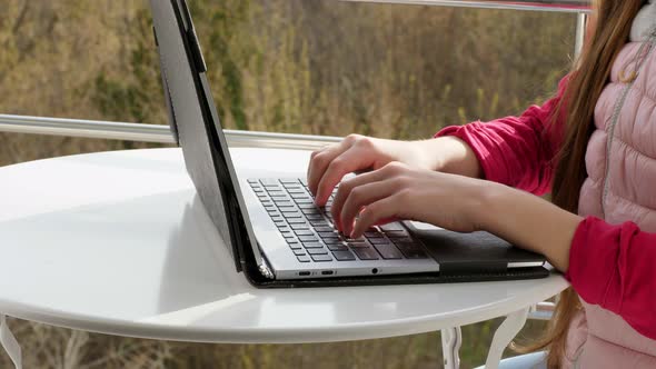 Close-up of Hands Typing on a Laptop Keyboard. Teenager Girl Typing, Working on Laptop, in Open