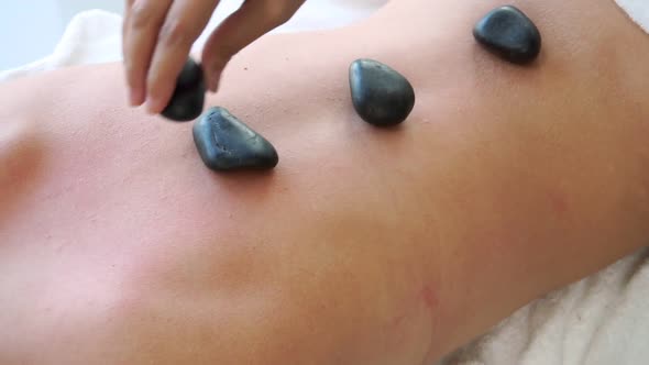 Hot Stone Massage Treatment By Therapist in Spa