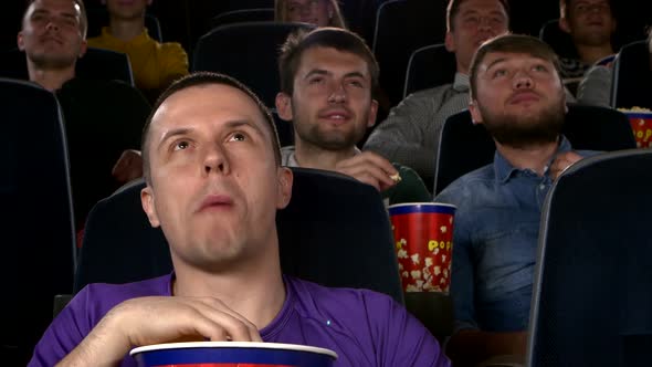 Young Mans Watching Movie at Cinema: Comedy. Close Up