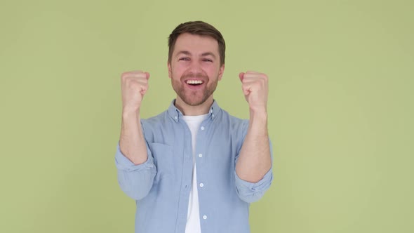 American Man in Denim Shirt White Tshirt Isolated on Yellowgreen Background in Studio