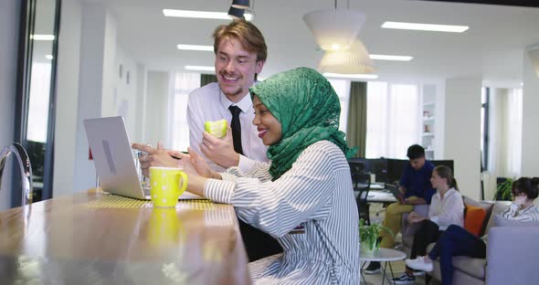 Black Woman with Hijab Meeting Business Man in Casual Startup Office Man Eating Apple on Meeting