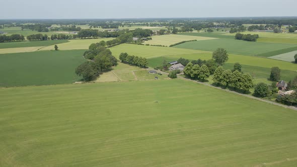 Flying towards beautiful old farm in a rural part of the Netherlands