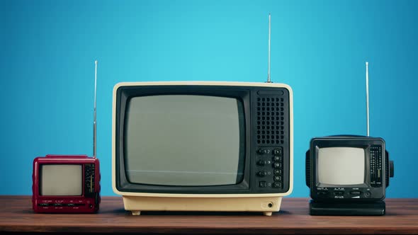 Old Televisions with Grey Interference Screen on Blue Background