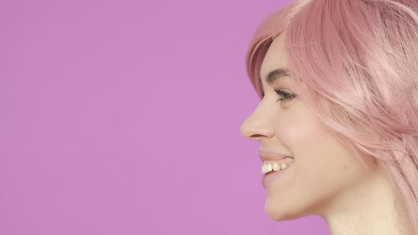 Slowmotion Profile Closeup of Adorable Young Woman in Kawaii Pink Wig Laughing and Smiling Watching