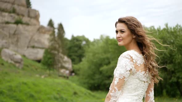 Beautiful Bride in Fashion Wedding Dress on Natural Background