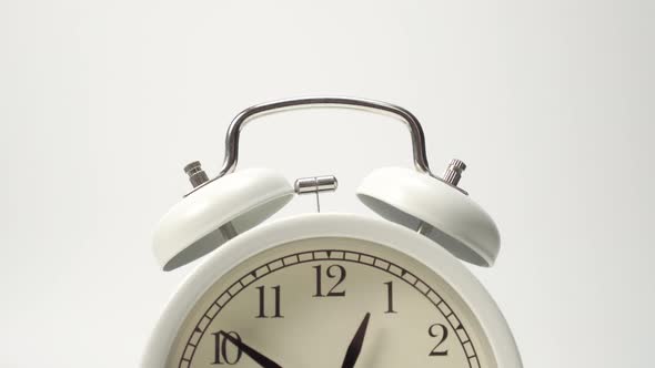 Metal bells White classic analog alarm clock close-up