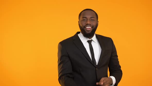 African-American Male Is Formal Suit Making Dancing Movements, Advertisement