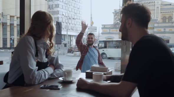 Couple Meets a Friend Through the Window and Waves at Him