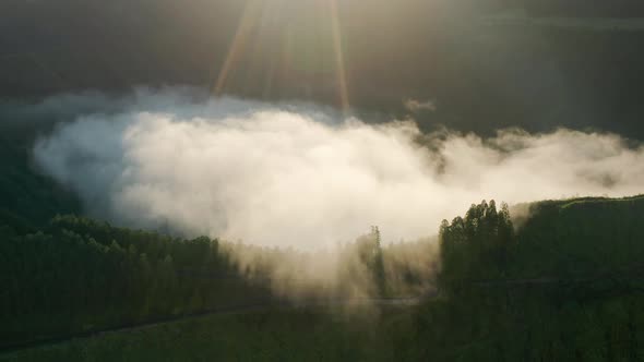 Sun Lights Breaking Through Clouds Over Lake Azul at Sunrise Azores