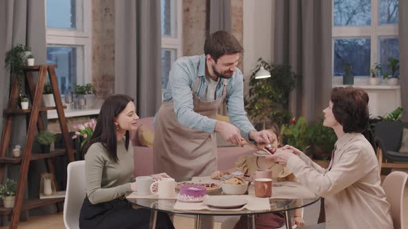 Man Taking Care Of Women At Dinner Table