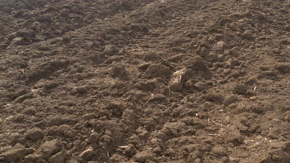 Above the ploughed fertile soil 4K aerial video