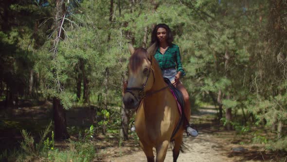 Lovely Female Riding Brown Horse on Rural Road