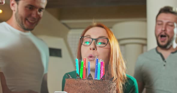 Portrait of Happy Smiling Caucasian Girl Blowing Candles with Her Birthday Cake Group of Friend