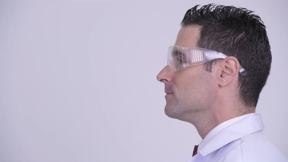 Head Shot Profile View of Handsome Man Doctor Wearing Protective Glasses Thinking