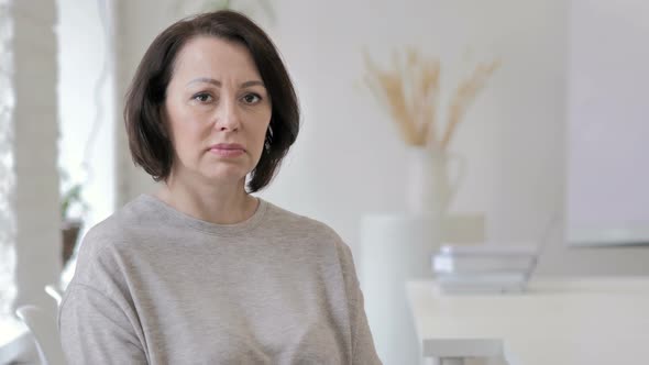 Portrait of Sad Old Senior Woman Looking at Camera