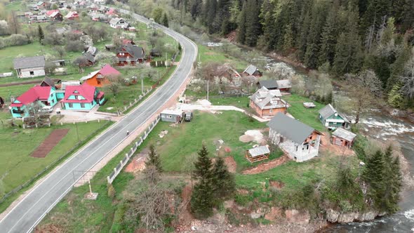 Mountain village. Carpathian mountains, Ukraine. Drone flying over pine tree forest