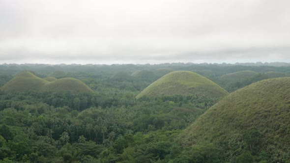 Slow motion shot of view over the famous Chocolate Hills on a cloudy day in Bohol, The Philippines