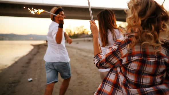 Happy Group of Friends Lighting Sparklers and Enjoying Freedom