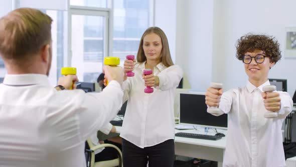 Office Workers Using Dumbbells