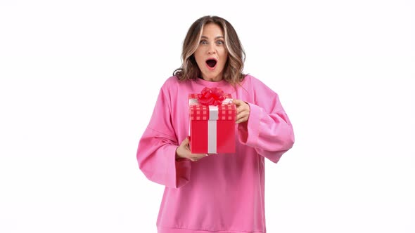 Excited Casual Woman Opening Red Wrapped Gift Box Rejoicing Isolated