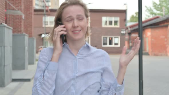 Woman Getting Angry on Call While Walking in Street