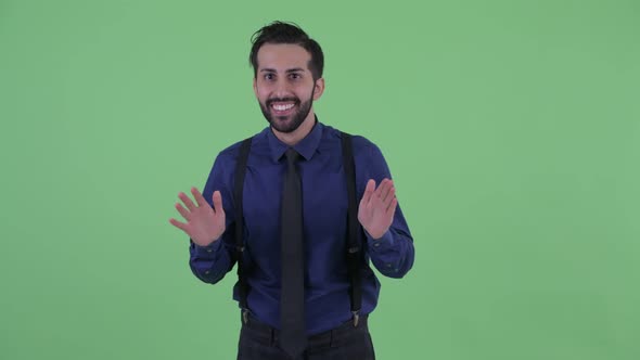 Happy Young Bearded Persian Businessman Looking Surprised