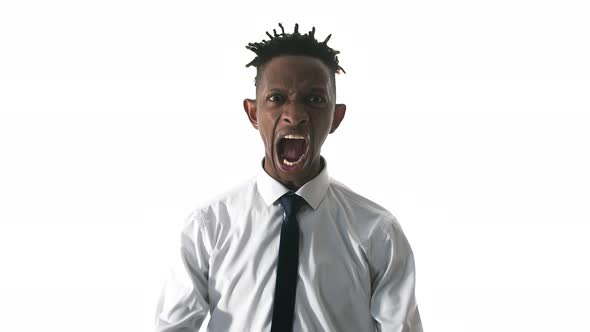 Black Indignant Man Screams with Anger and Clenches Fists on White Background