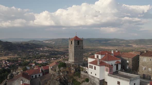 Monsanto mountain village with iconic Lucano Tower and its Silver Rooster; drone