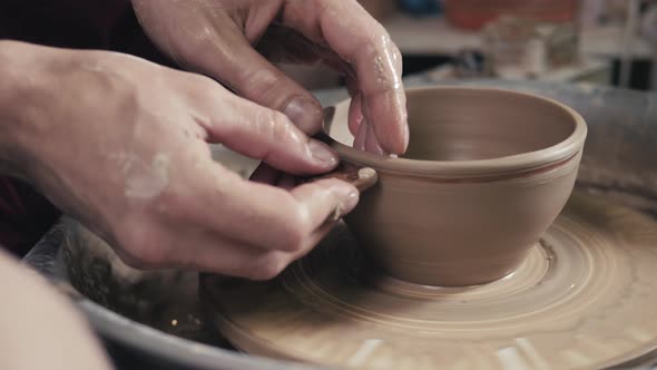 Hands of the Master Potter and Vase of Clay on the Potter's Wheel Closeup