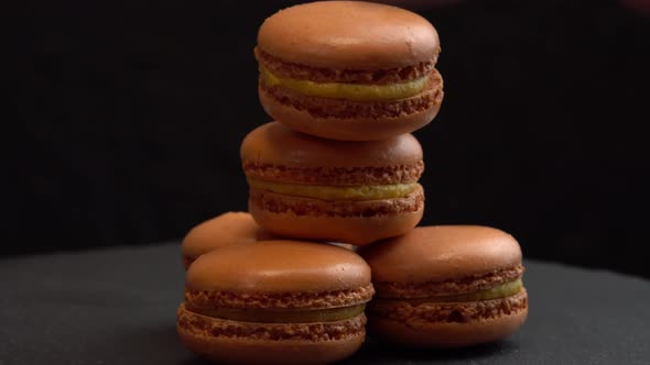 Macaroon Candy Rotate on a Black Surface for Background Sweets are Spinning Macro