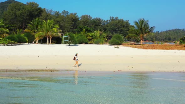 Women enjoying life on beautiful sea view beach vacation by blue ocean and clean sandy background of