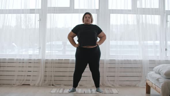 A Fat Woman Doing Warming Up Exercises at Home