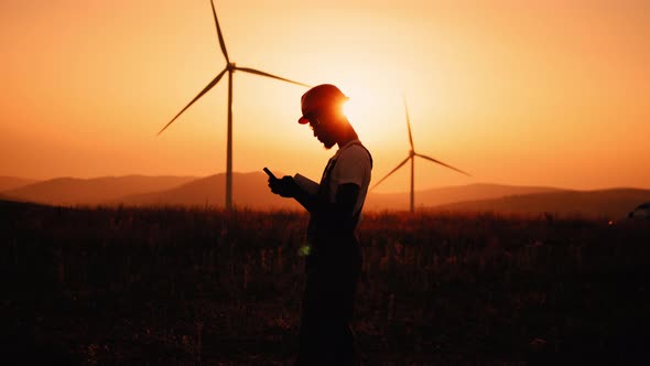 Silhouette African American Industrial Worker Having Mobile Conversation While