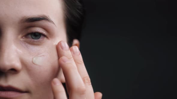 Eye Skin Beauty. Woman Apply Eye Patch Mask on Face at Bathroom.