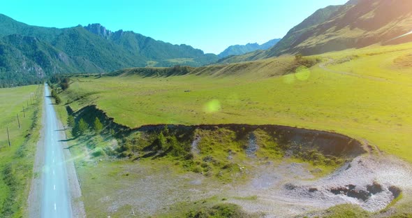 Aerial Rural Mountain Road and Meadow at Sunny Summer Morning, Asphalt Highway and River